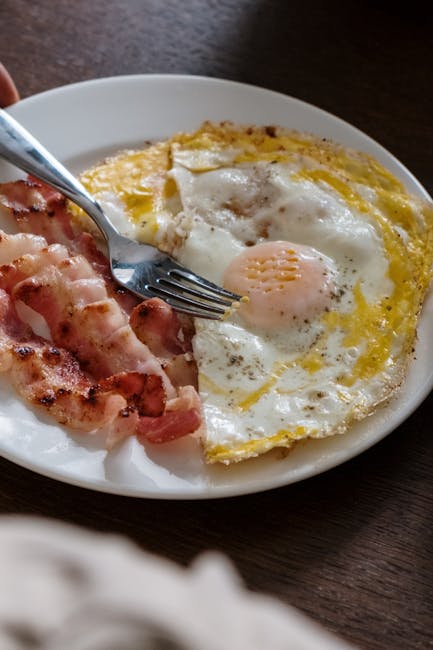 A hearty breakfast plate with fried eggs and crispy bacon, perfect start to the day.