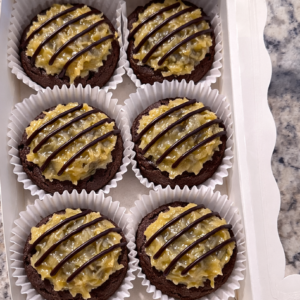 6 German Chocolate Cookies in a white bakery box on the countertop