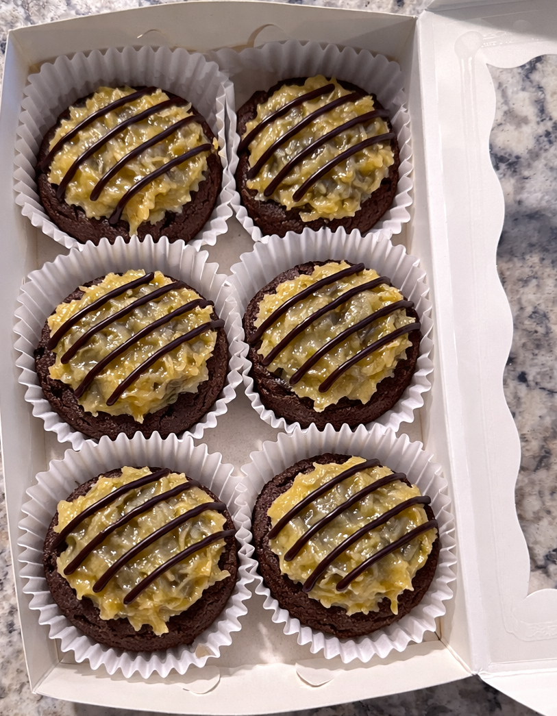 6 German Chocolate Cookies in a white bakery box on the countertop